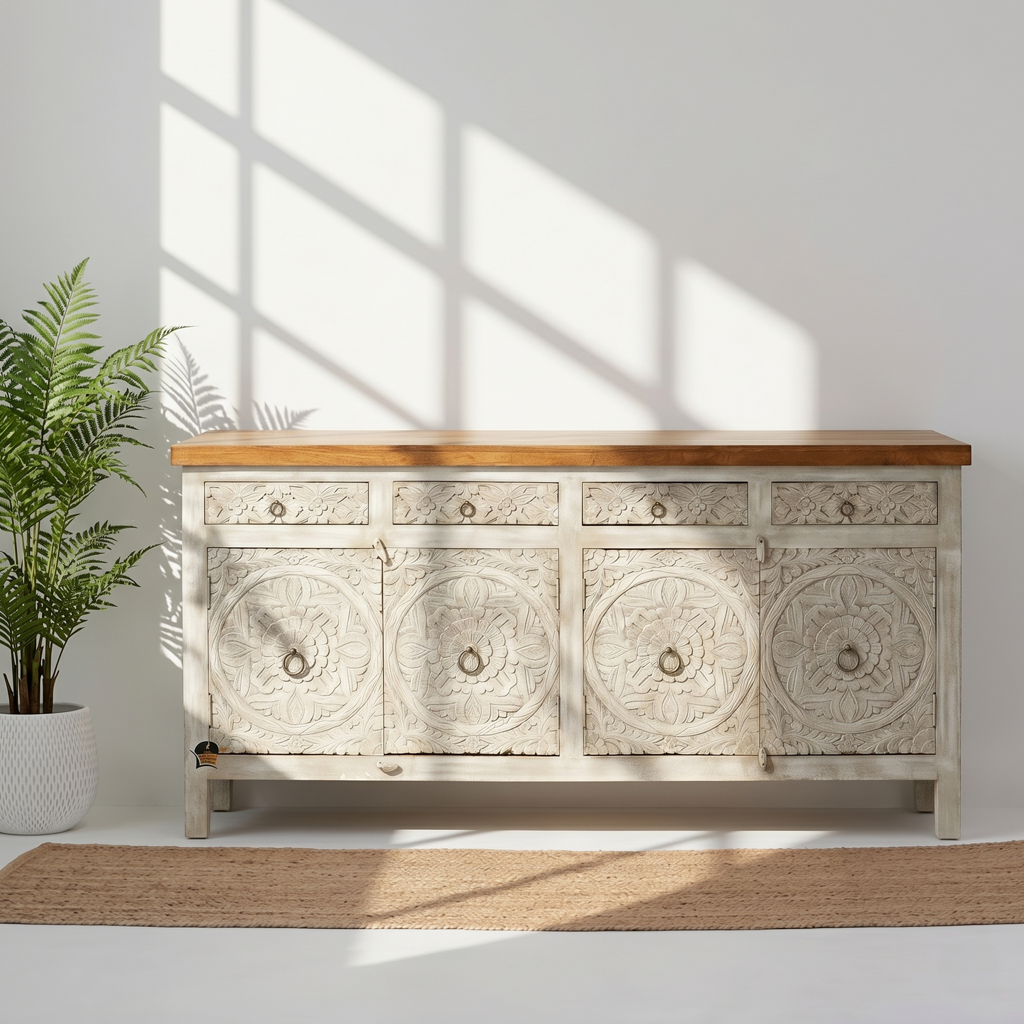 Decorative wooden sideboard with carved patterns in a bright room with sunlight streaming through a window.